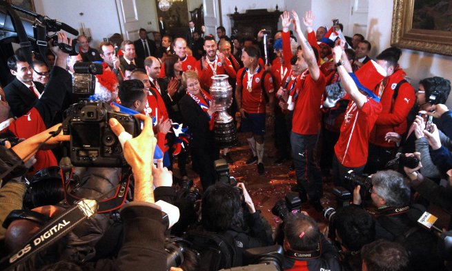El plantel de la selección chilena llegó hasta el Palacio de La Moneda para festejar junto a la Presidenta, Michelle Bachelet, y miles de hinchas, la obtención de la Copa América 2015. El plantel de la selección chilena llegó hasta el Palacio de La Moneda para festejar junto a la Presidenta, Michelle Bachelet, y miles de hinchas, la obtención de la Copa América 2015.